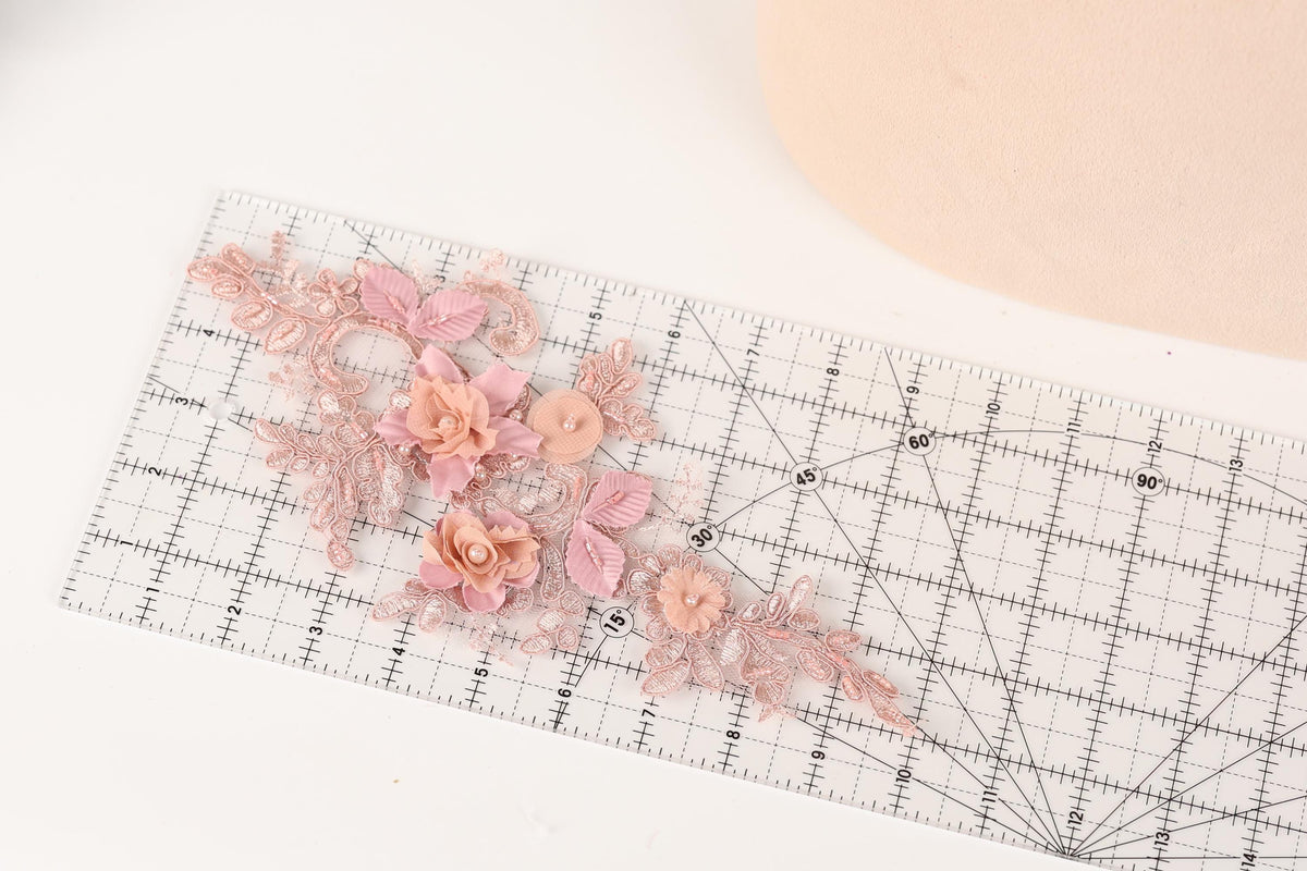 a clear ruler with a floral design on it, placed on a white surface.