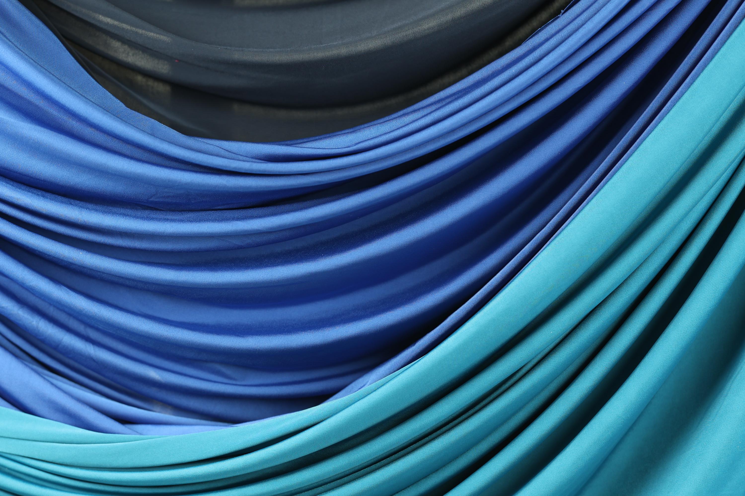 a close-up view of a fabric with a gradient of blue and black colors, creating a visually striking and textured appearance.