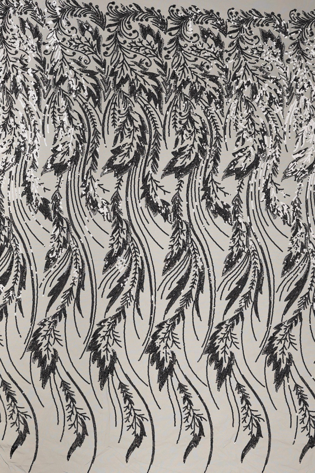 a repeating pattern of black and white feathers or leaves, creating a visually striking and intricate design.