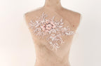 A mannequin with a delicate, floral embroidered patch on its bust.