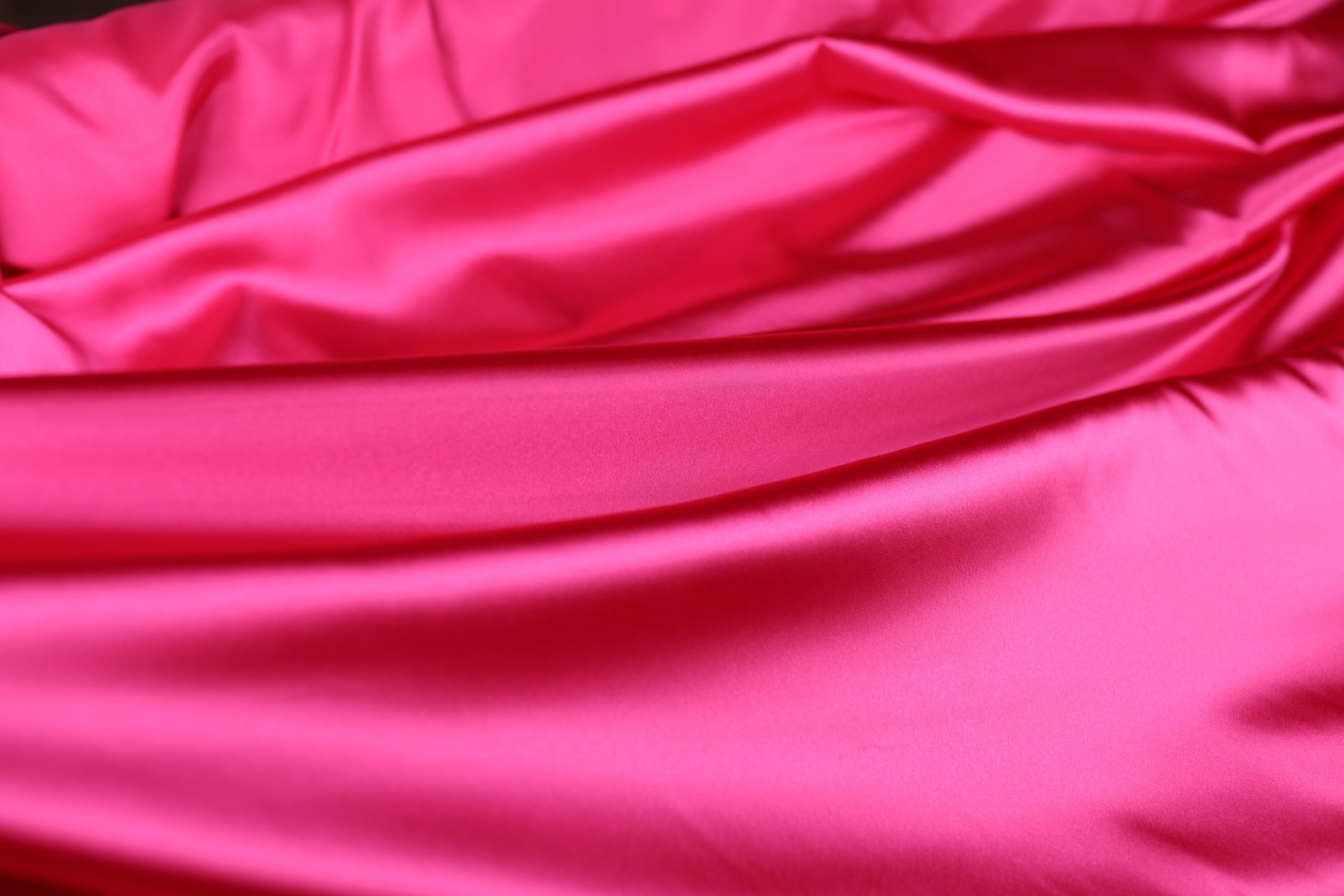 a close up of a pink satin material