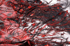 The image is a close-up of a fabric with a striking pattern of red and black sequins and beads, creating a visually captivating and intricate design.