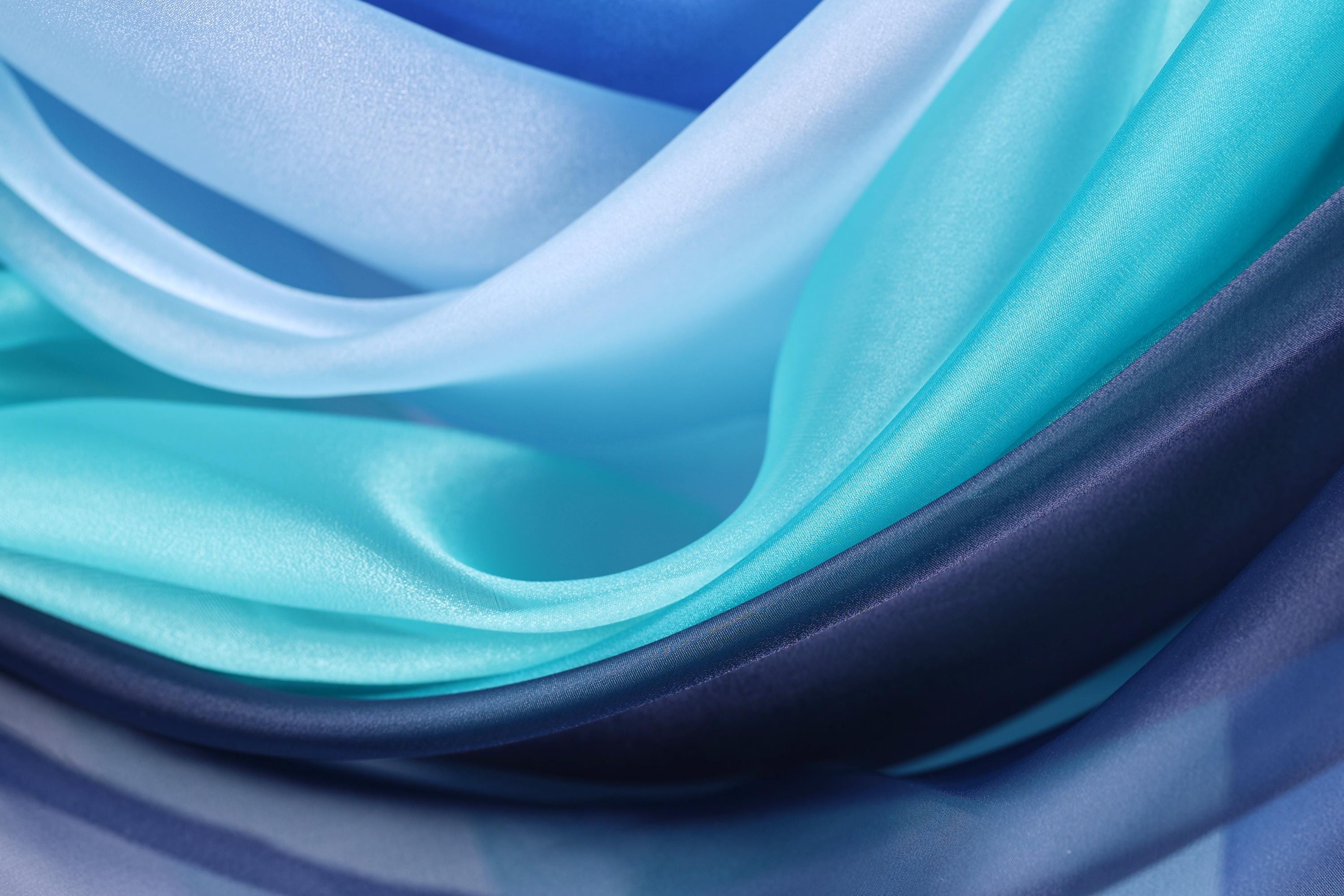 The image is a close-up of a fabric with a blue and white color scheme, featuring a variety of shades of blue and white.