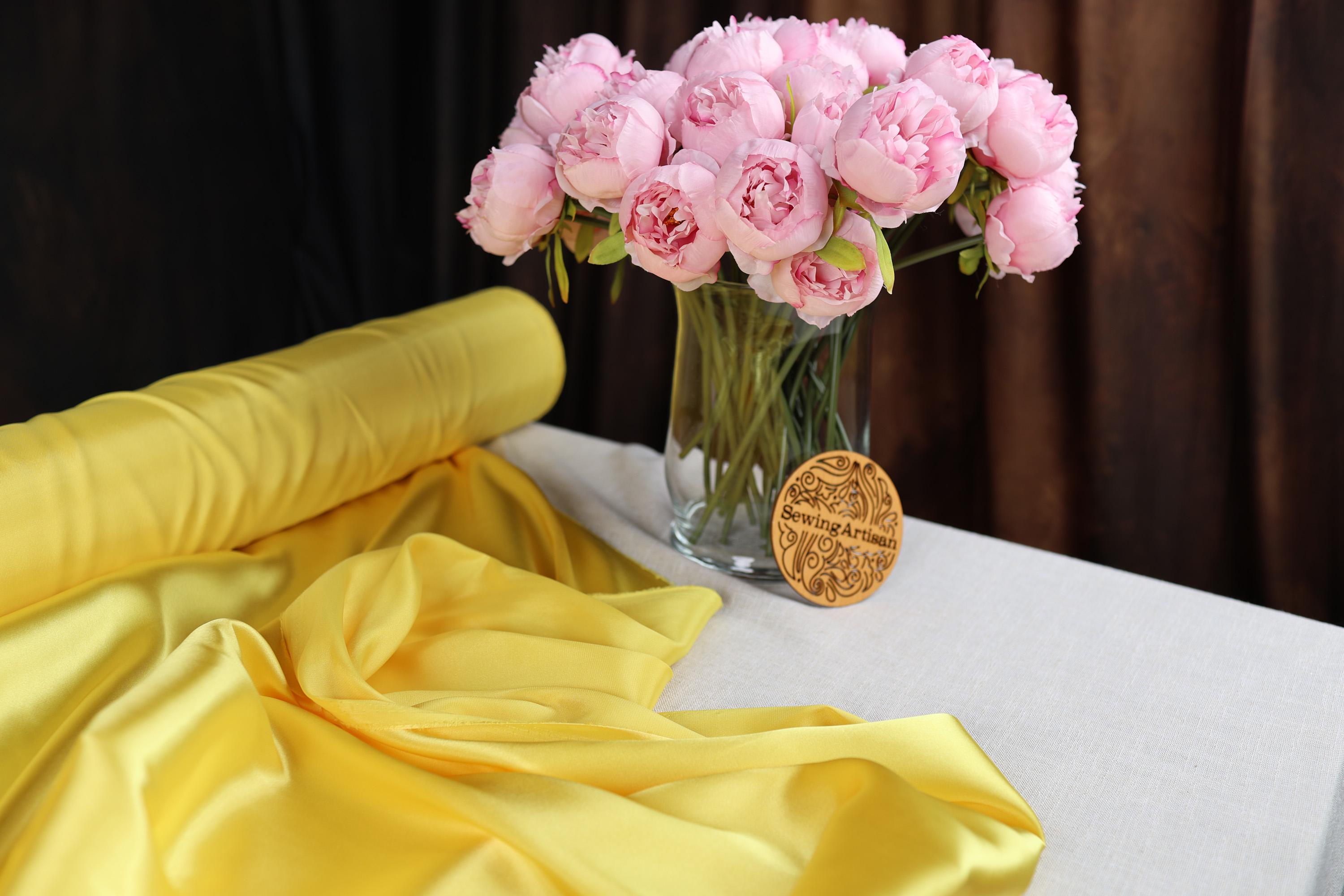 a vase filled with pink flowers on top of a table