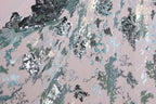 The image is a close-up view of a fabric with a pattern of sequins and glitter in shades of blue, green, and silver. The fabric appears to be a piece of clothing or textile, with the intricate design and shimmering sequins creating a visually striking and textured appearance.
