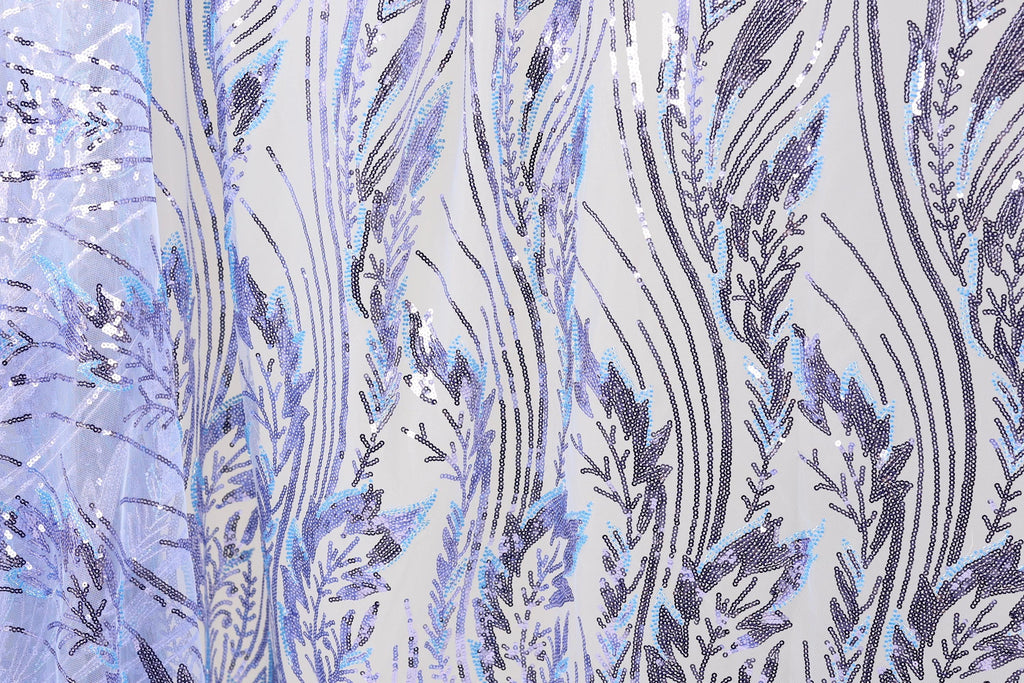 a close-up view of a fabric with a repeating pattern of purple and blue sequin designs. The pattern consists of various lines and shapes, creating a visually striking and intricate design. The fabric appears to be a piece of clothing or textile, with the sequin designs adding a touch of sparkle and texture to the overall appearance.