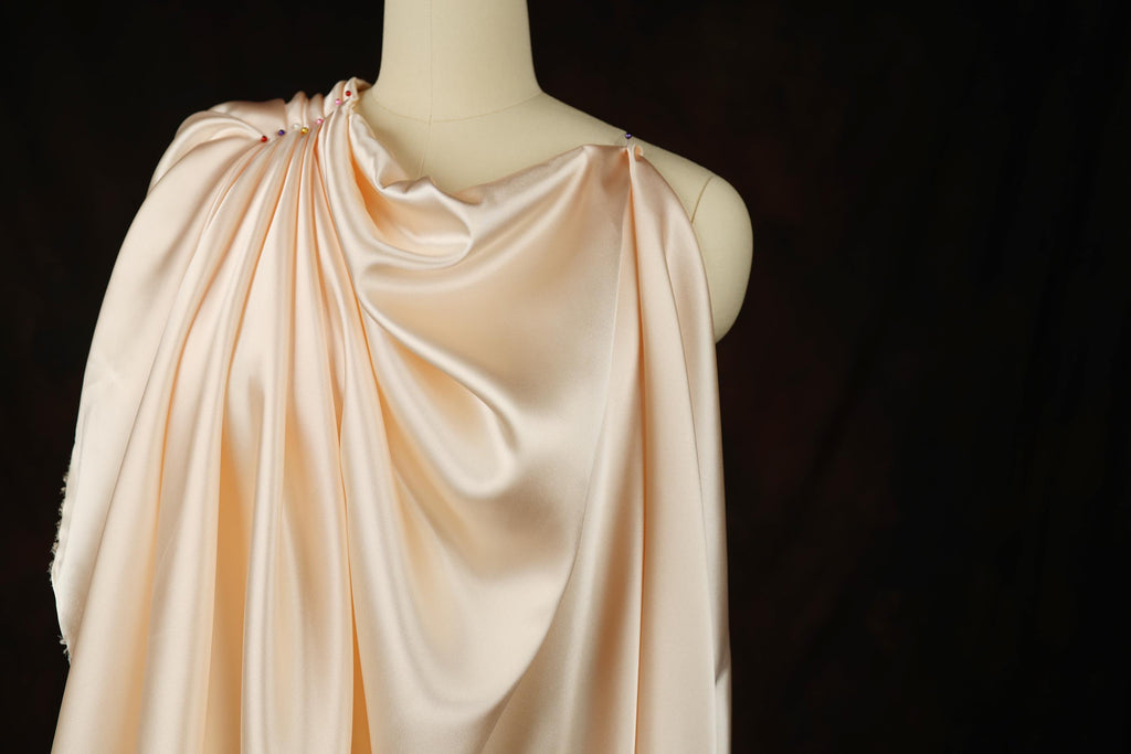 a mannequin wearing a pink dress on a black background