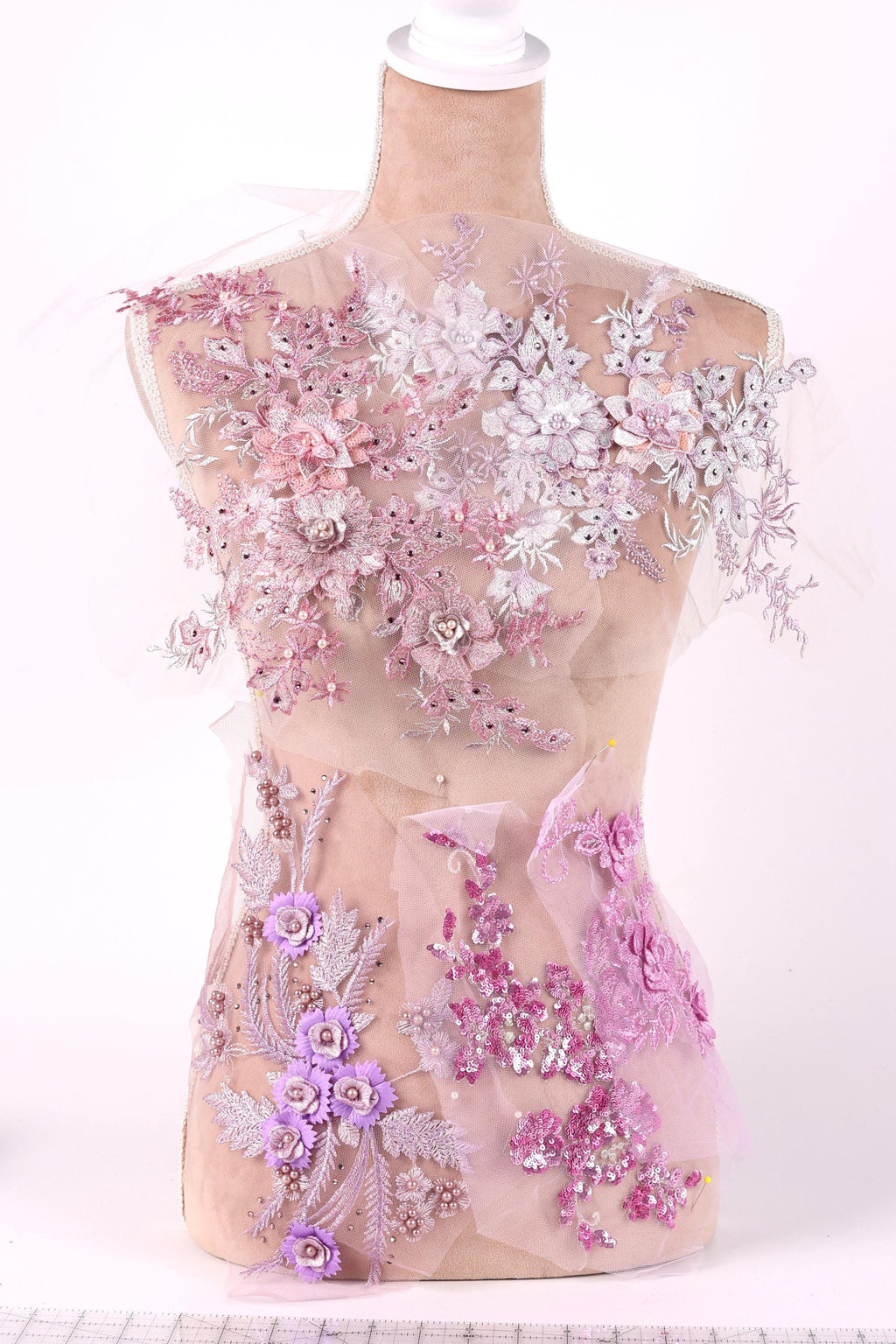 A mannequin wearing a dress with a floral pattern in shades of pink and white.