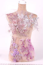 A mannequin wearing a dress with a floral pattern in shades of pink and white.