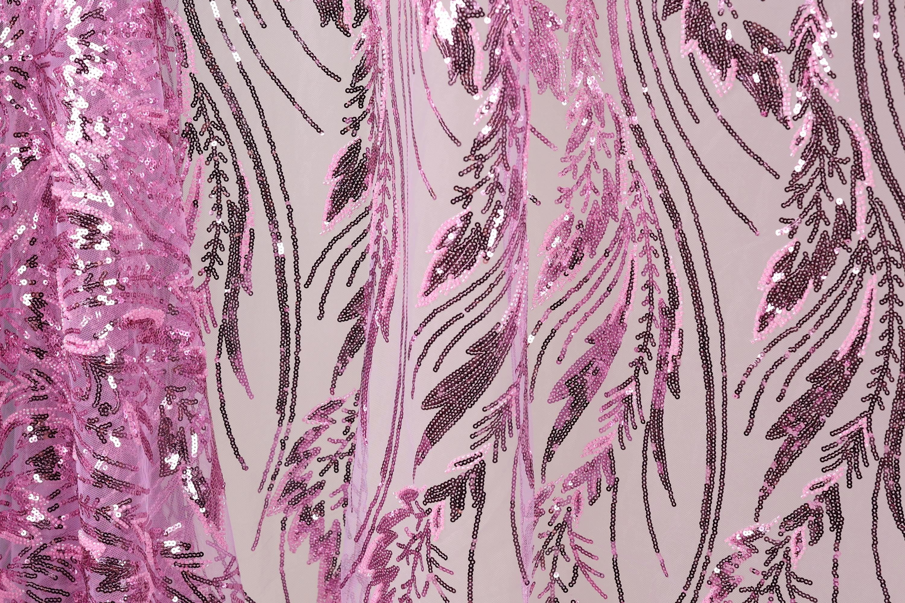 a close-up view of a fabric with a pink and black sequin pattern. The fabric appears to be a sheer material, with the pink sequins creating a visually striking contrast against the black background. The pattern consists of numerous sequins arranged in a repeating design, creating a sense of depth and texture. The image does not contain any discernible text or countable objects, and the focus is solely on the intricate and visually appealing pattern of the sequins.