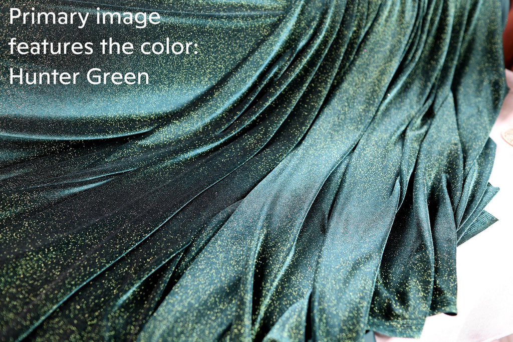 a close-up view of a shiny, green fabric with a glittery texture, resembling a piece of jewelry or a decorative material.