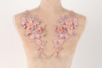 A mannequin torso with delicate pink floral embroidery on the shoulders.