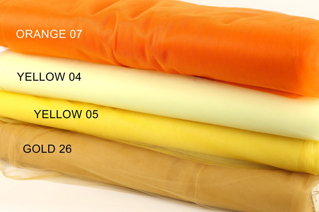a stack of four fabric swatches, each with a different color: orange, yellow, yellow, and gold.
