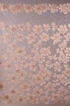 a close-up view of a fabric with a floral pattern. The fabric is adorned with numerous small, delicate flowers in shades of pink and white, creating a visually appealing and intricate design. The flowers are arranged in a repeating pattern across the fabric, adding a sense of depth and texture to the overall composition.