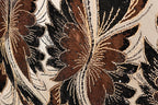 a close-up view of a fabric with a floral pattern, showcasing intricate details and textures.