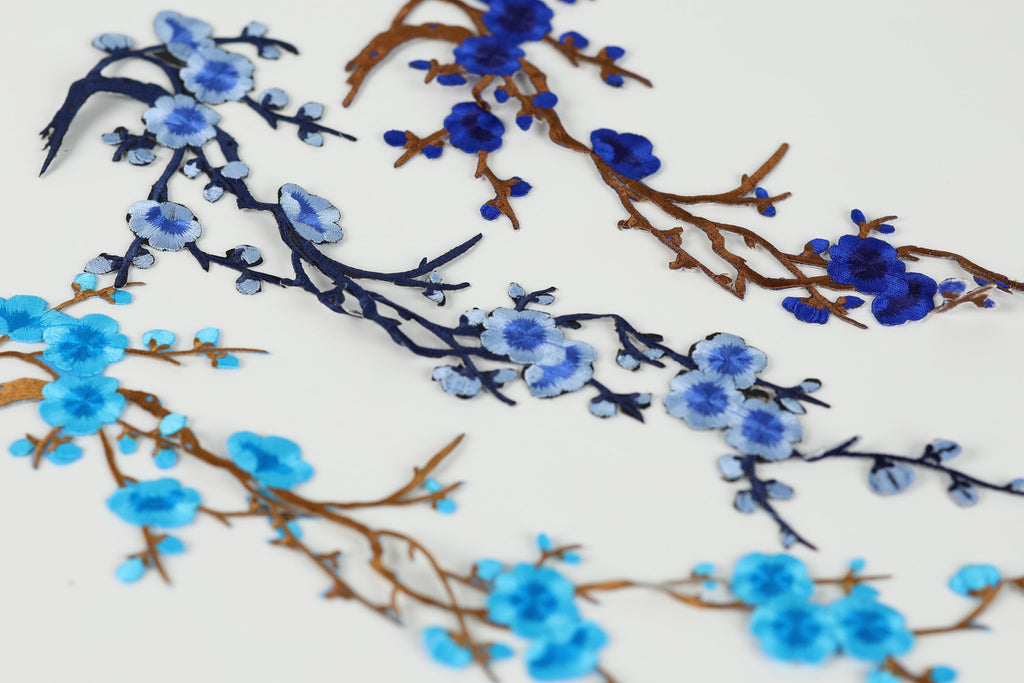 a close-up view of blue and brown branches with blue flowers, creating a visually appealing and intricate design.