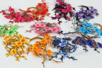 a variety of colorful flowers and branches, including red, pink, purple, blue, and yellow flowers, as well as green and orange branches, arranged in a visually appealing manner.