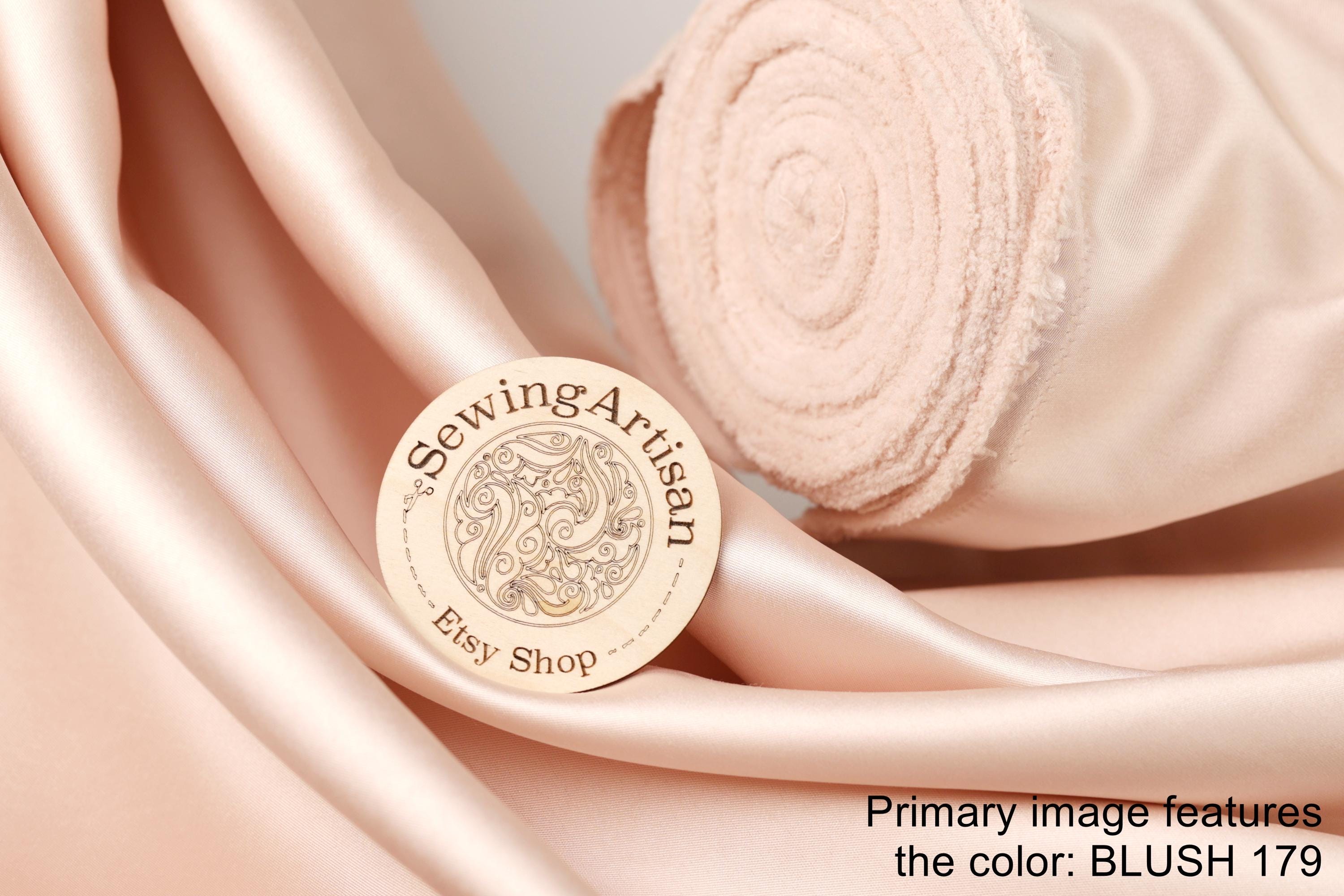 a pink fabric with a circular logo that says "Sewing Artist" and "Etsy Shop", along with the text "BLUSH 179".