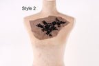 A mannequin with a piece of fabric on its chest, featuring a floral pattern.