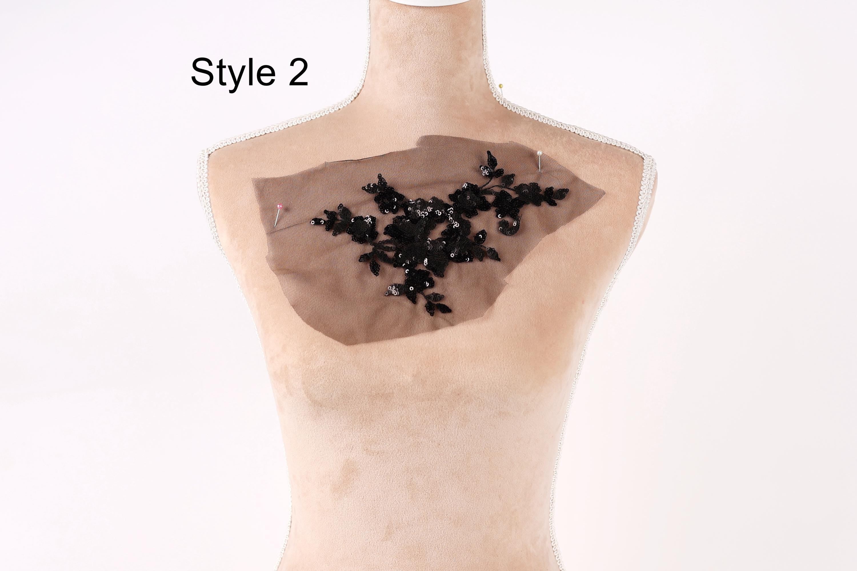 A mannequin with a piece of fabric on its chest, featuring a floral pattern.