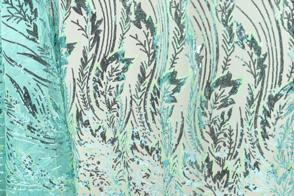 a close-up view of a fabric with a repeating pattern of green and black lines and shapes, creating a visually striking and intricate design.