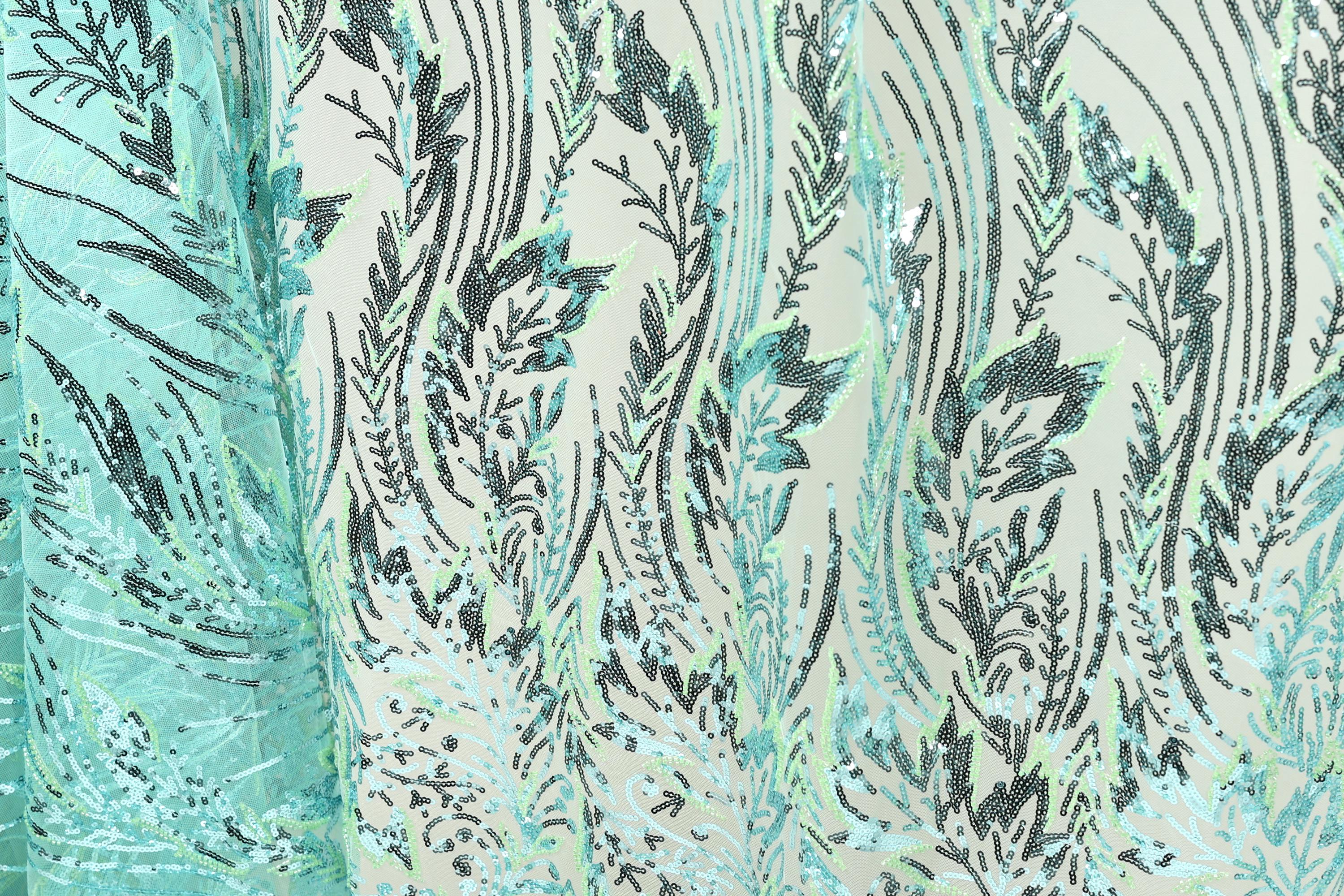 a close-up view of a fabric with a repeating pattern of green and black lines and shapes, creating a visually striking and intricate design.