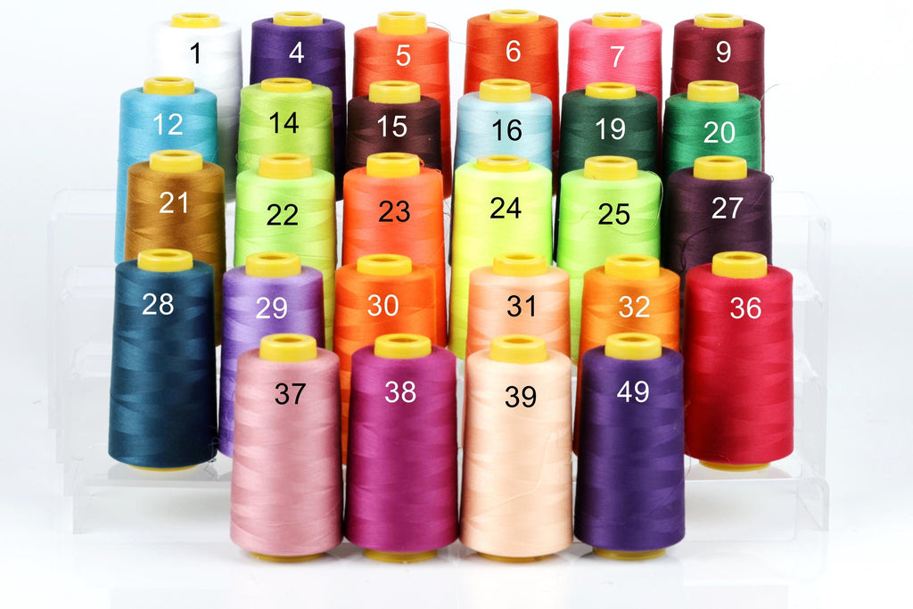 A collection of colorful spools of thread, each with a unique number, arranged in rows on a white background.