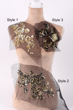 A mannequin with three different styles of fabric or material displayed on it, each with unique floral or leaf designs.