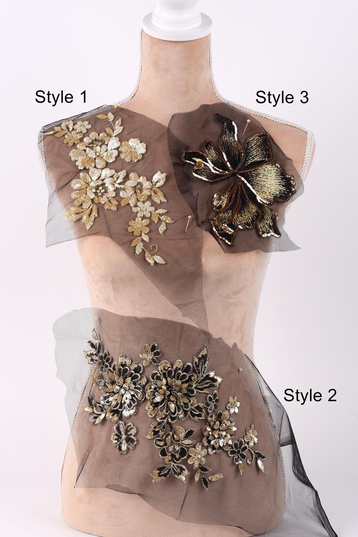 A mannequin with three different styles of fabric or material displayed on it, each with unique floral or leaf designs.