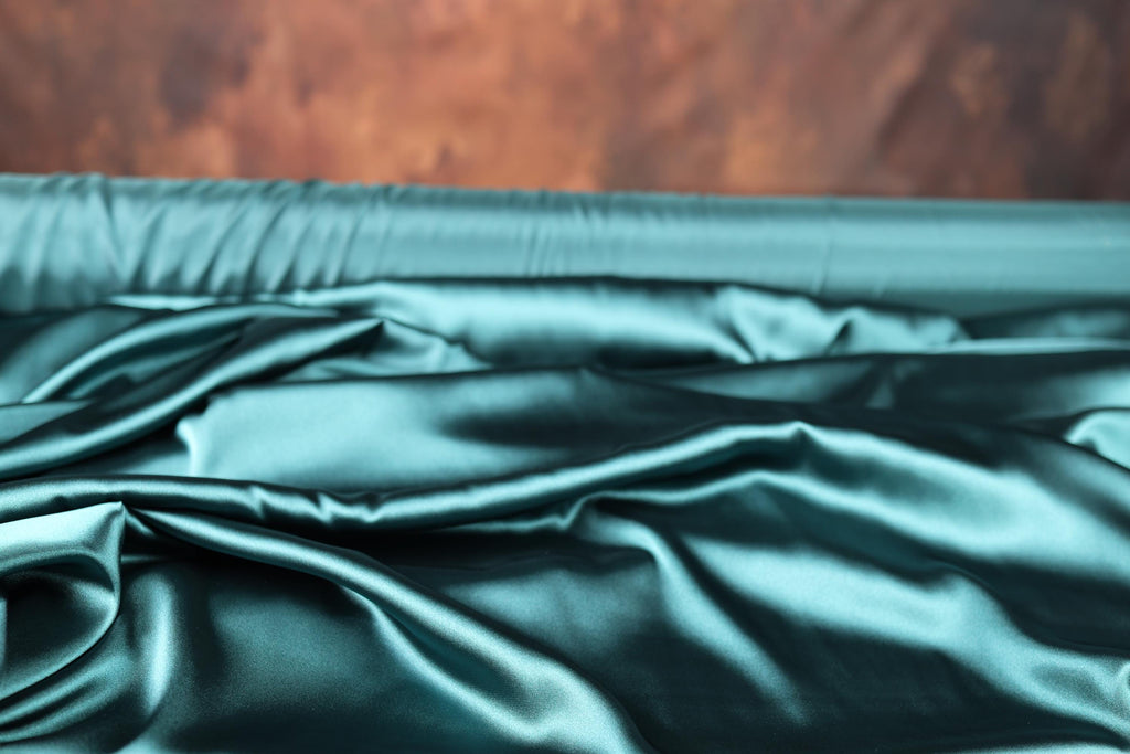 a close up of a satin material with a wood background