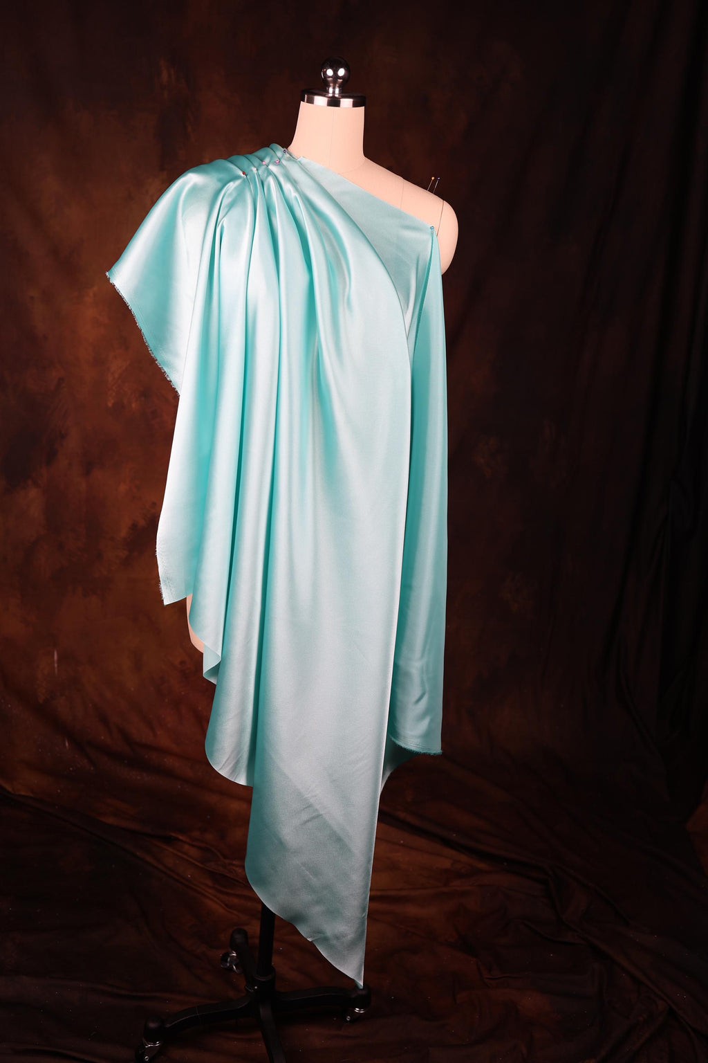 a dress on a mannequin on a brown background