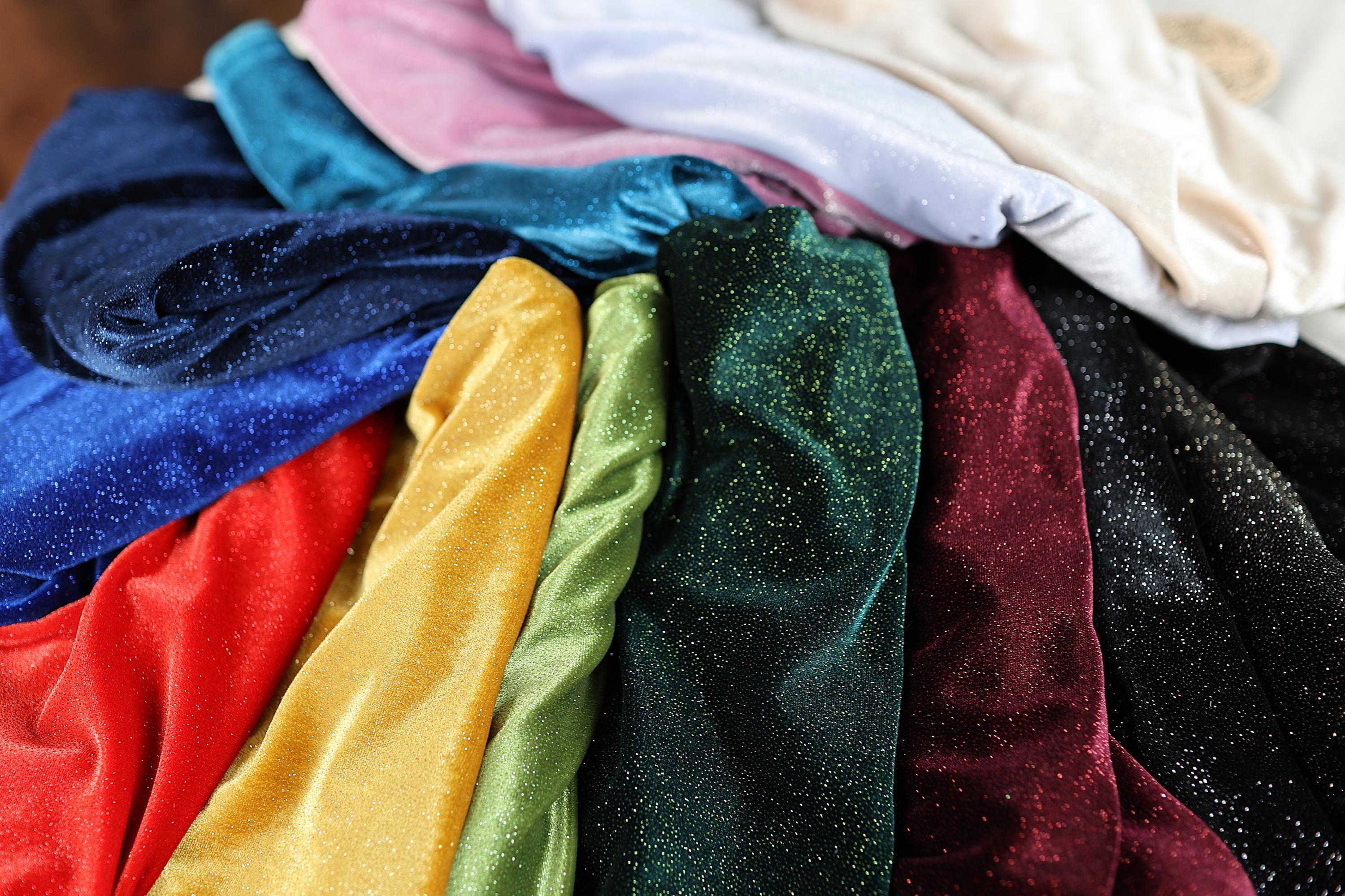a pile of different colored cloths sitting on top of each other