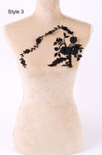 A mannequin with a floral embroidered patch on its shoulder.