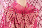 A close-up view of a mannequin wearing a pink sequin shawl or cape.