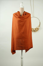 a mannequin wearing a bright orange shawl, which is displayed on a white mannequin stand against a white background.