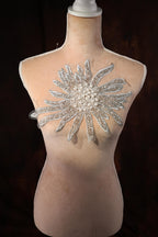 a mannequin with a large crystal flower on it