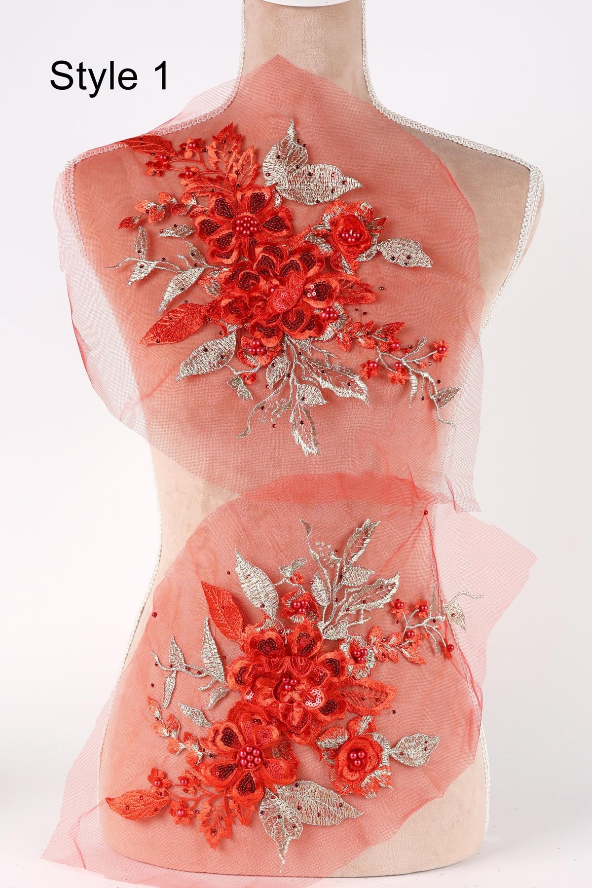 A mannequin wearing a red dress with a floral pattern on the back.