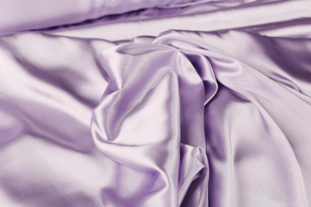 a close up of a purple satin material
