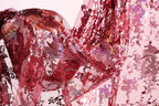 a close-up view of a red, sequined fabric with a floral pattern. The fabric appears to be made of sheer material, and the intricate design and texture of the sequins create a visually striking and vibrant appearance.