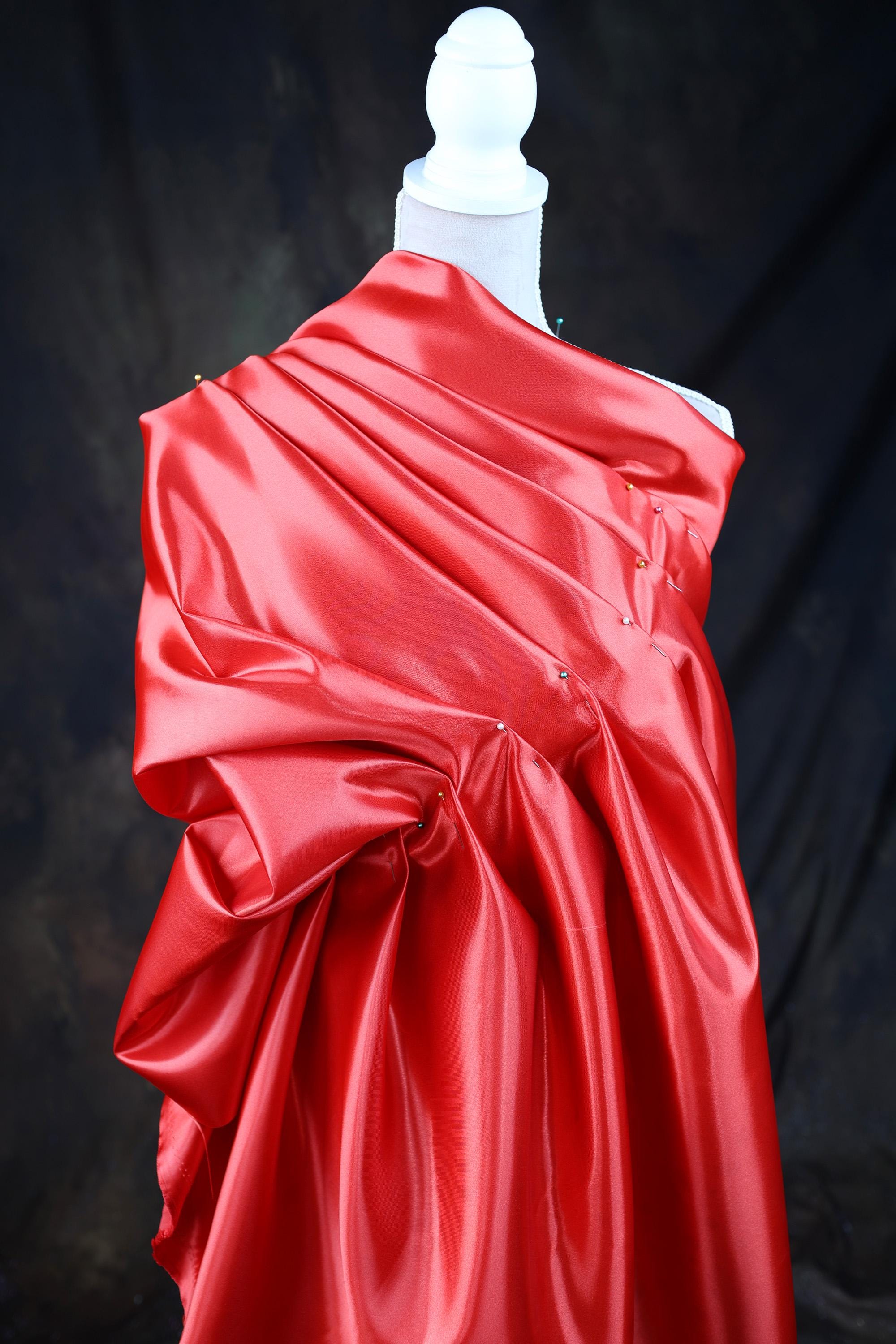 a mannequin is dressed in a red dress