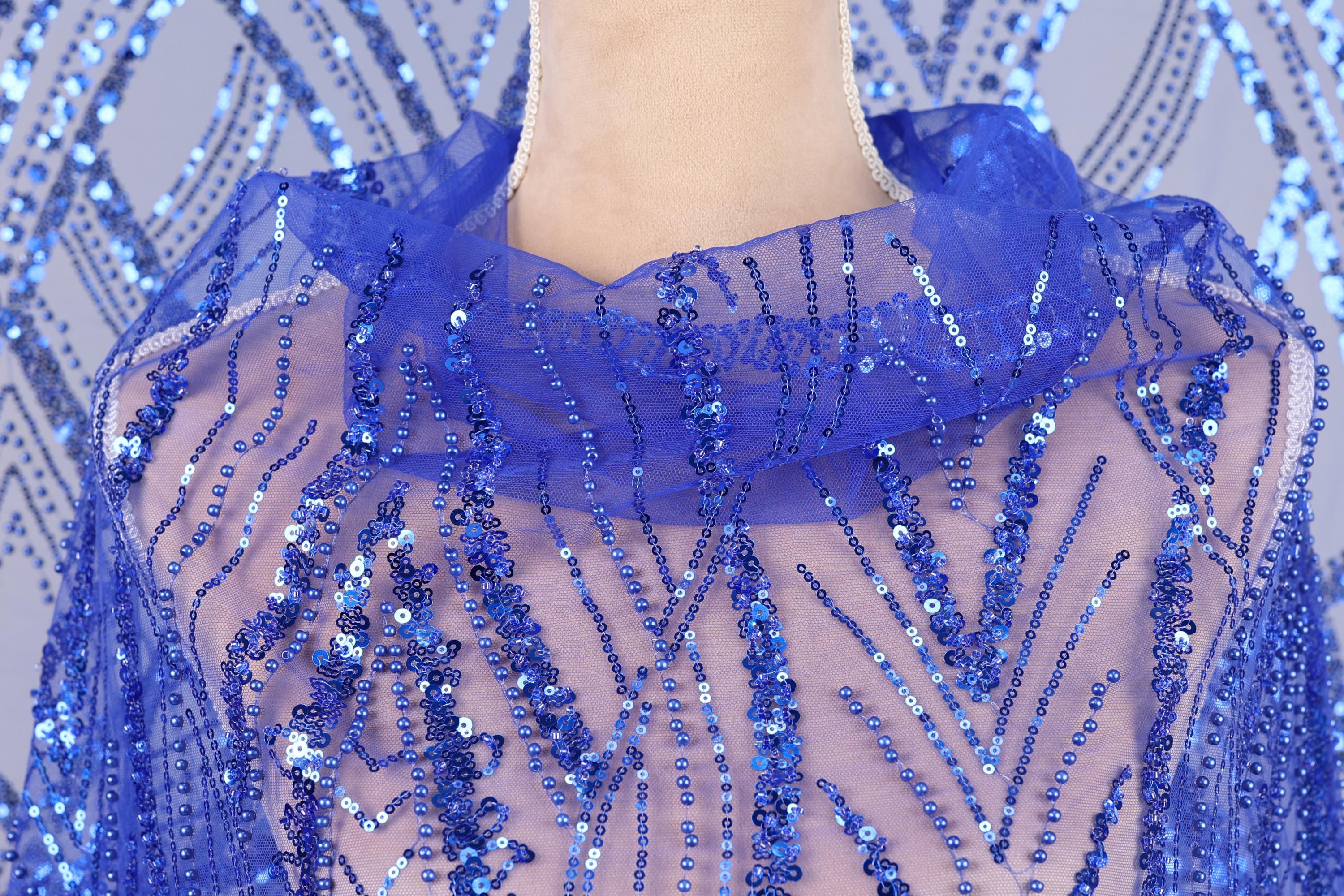 A close-up view of a mannequin wearing a blue sequin dress with a sheer, sheer-like fabric.