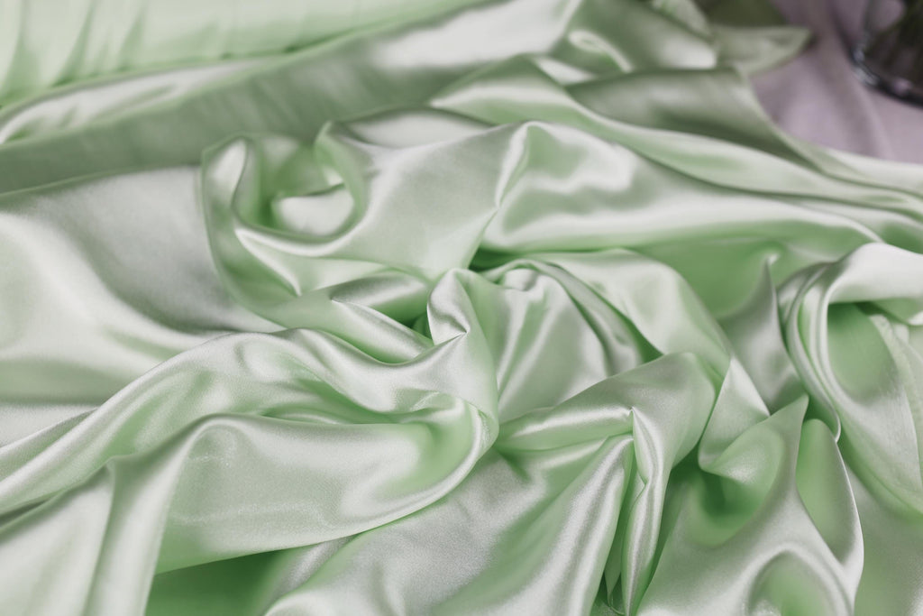 a close up of a green satin material