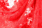The image is a close-up of a red fabric with a floral pattern, featuring a lot of small details and textures.