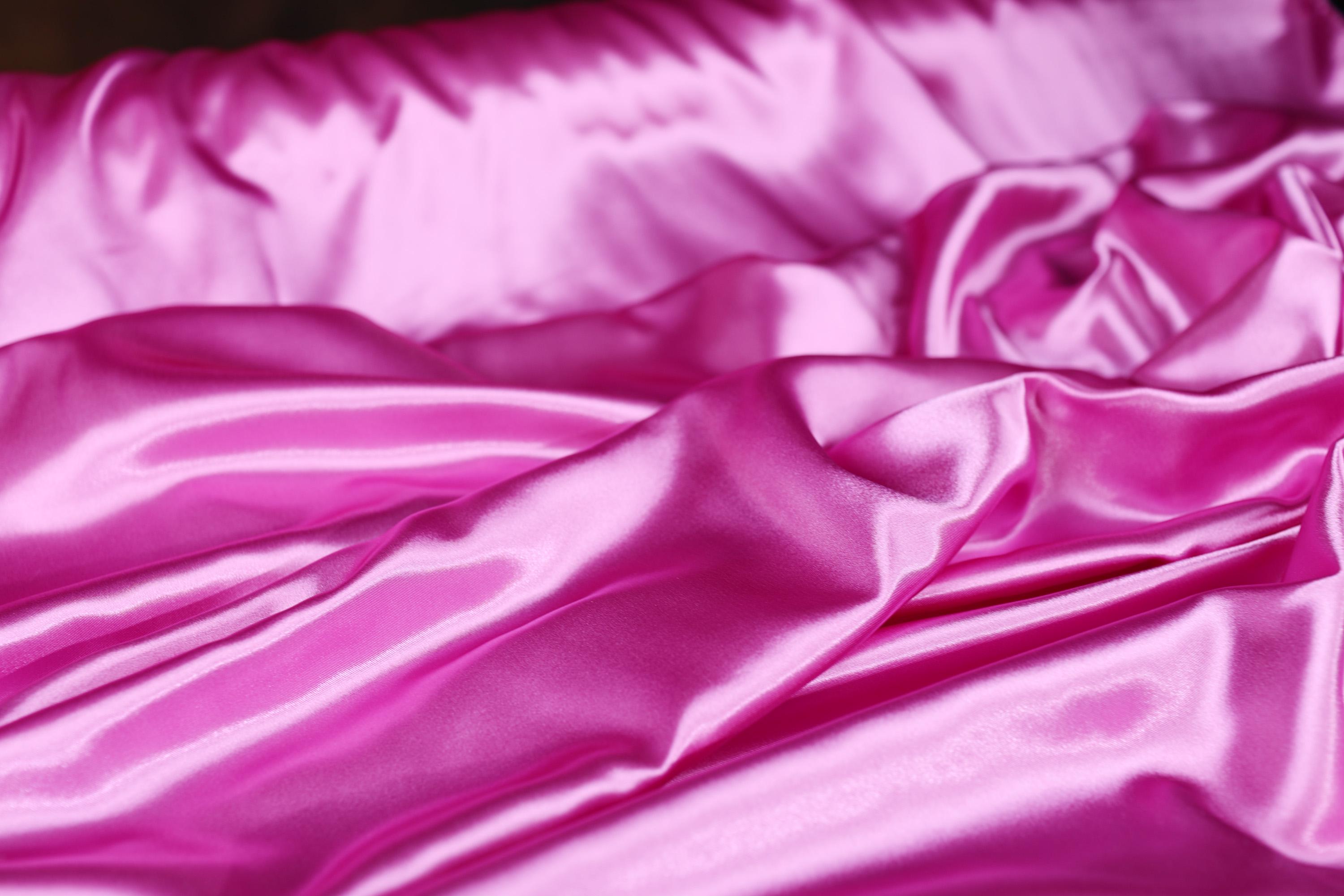 a close up of a pink satin material
