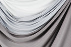 a close-up view of a fabric with a gradient of gray and white colors, creating a visually appealing and textured appearance.