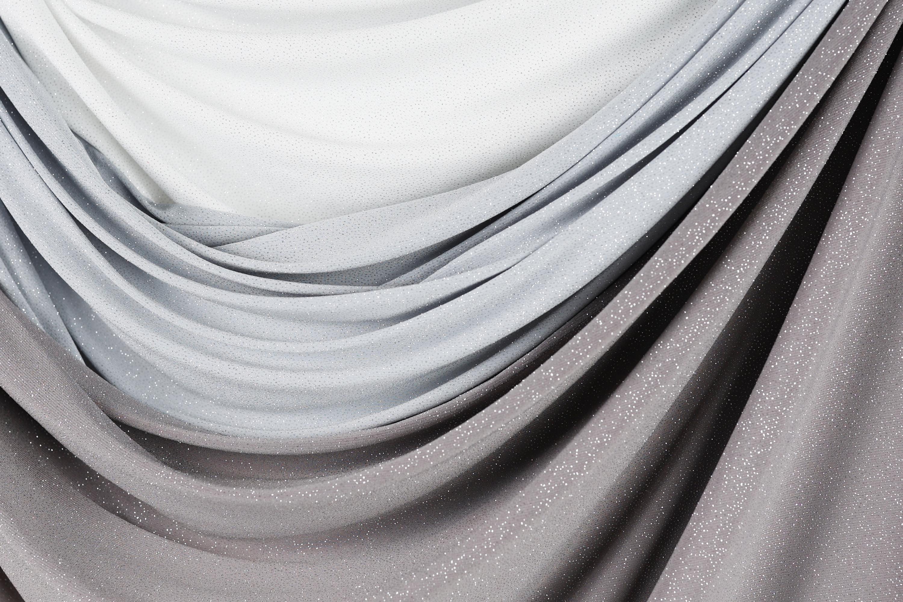 a close-up view of a fabric with a gradient of gray and white colors, creating a visually appealing and textured appearance.