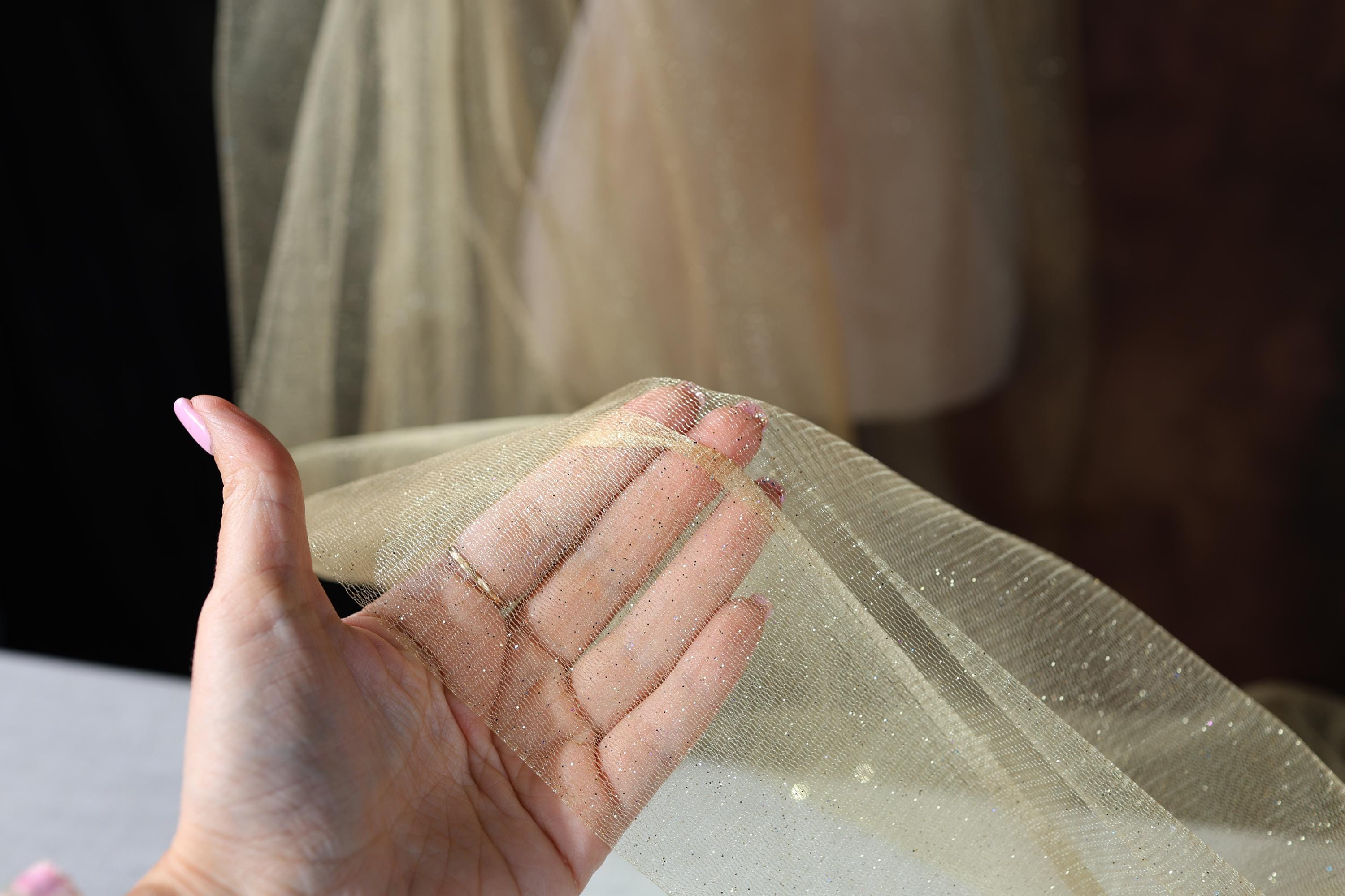 a woman wearing a veil and holding her hand out