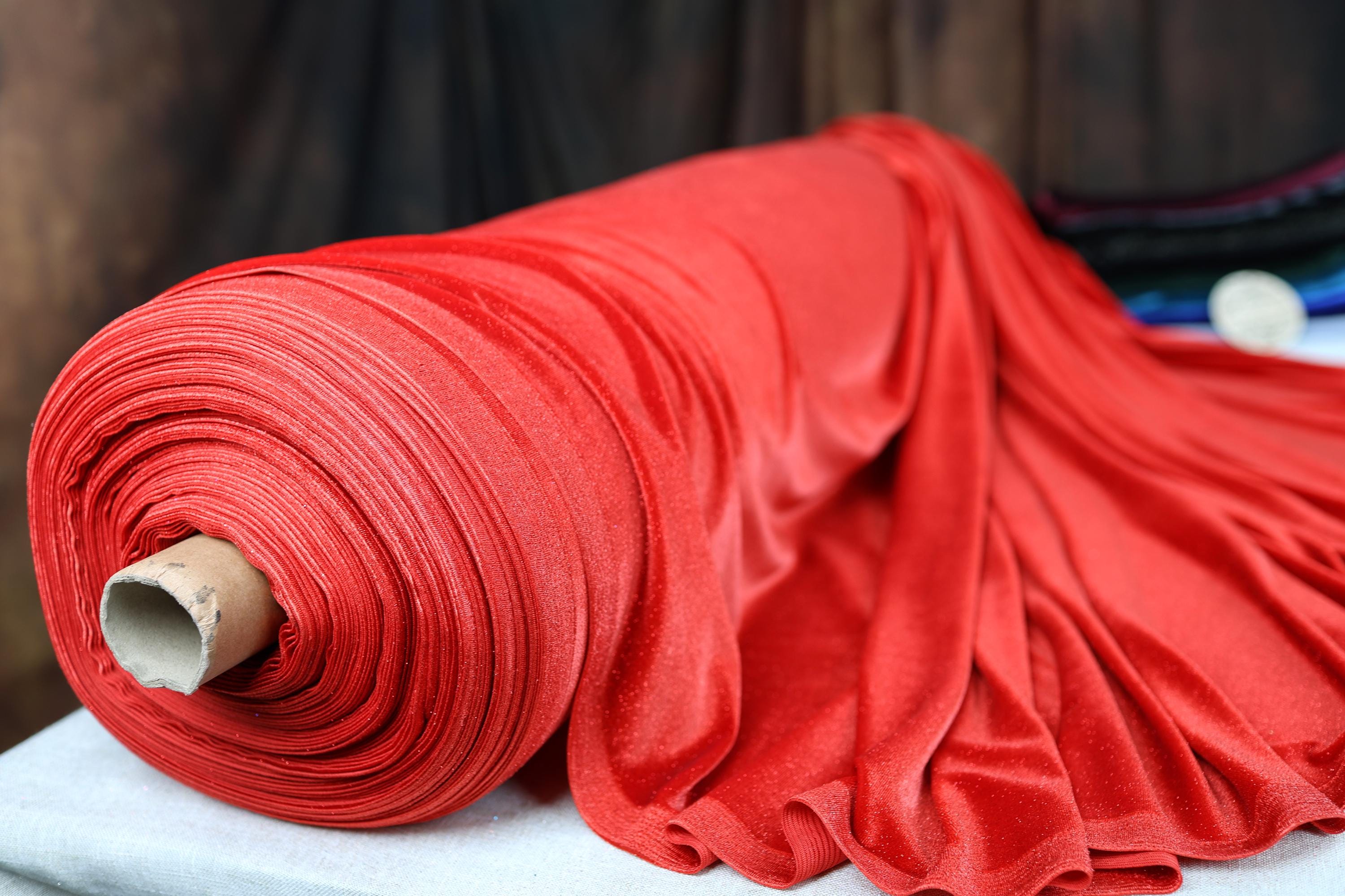 a roll of red fabric sitting on top of a table