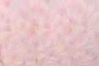 a pattern of pink and yellow flowers with glittering details, creating a visually striking and vibrant design.