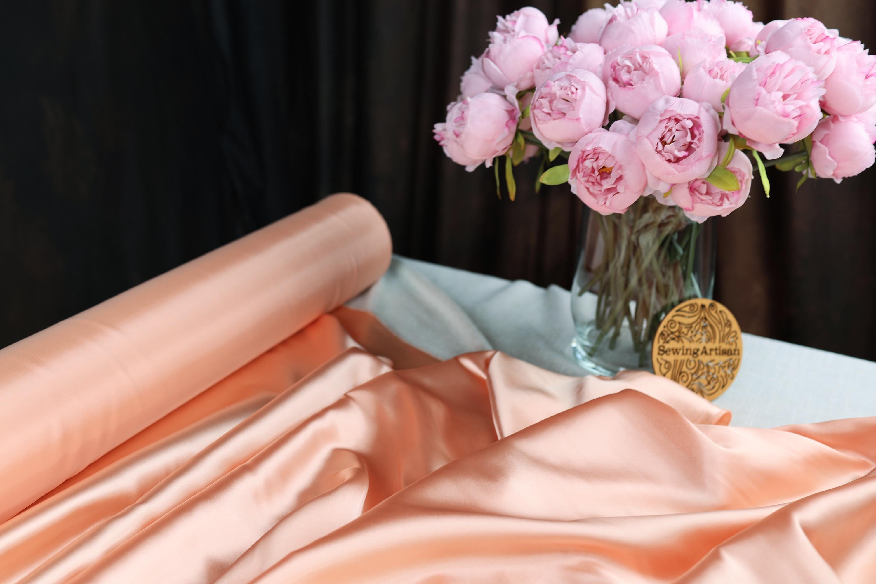 a vase filled with pink flowers on top of a table